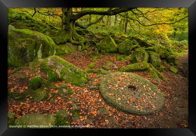 Beautiful vibrant Autumn Fall forest landscape image of millstone in woodland in Peak District Framed Print by Matthew Gibson