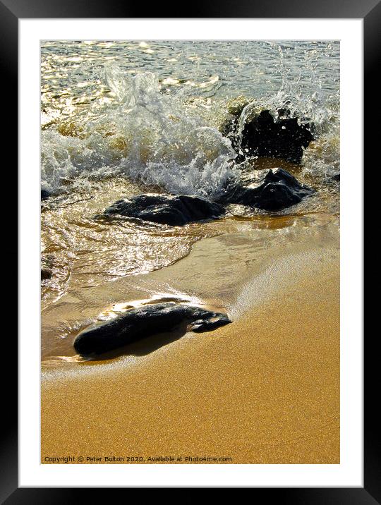 Stones on a beach with the incoming tide lapping around. Cornwall, UK. Framed Mounted Print by Peter Bolton