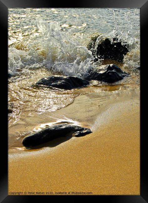 Stones on a beach with the incoming tide lapping around. Cornwall, UK. Framed Print by Peter Bolton