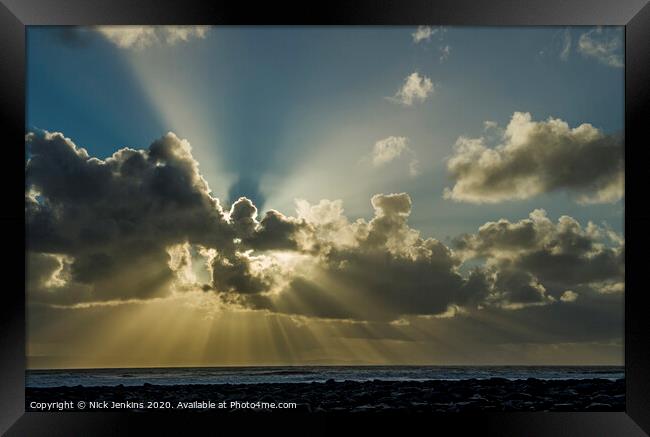 A large sunburst over Llantwit Major Beach Wales Framed Print by Nick Jenkins
