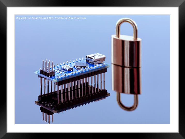 Padlock next to the computer chip - the concept of electronic data protection technology Framed Mounted Print by Sergii Petruk
