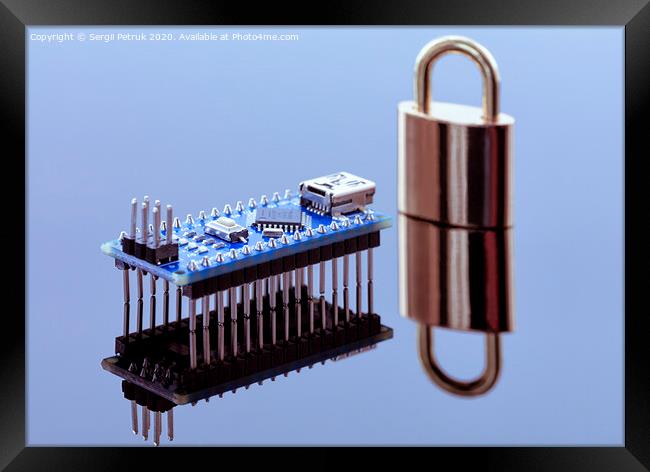 Padlock next to the computer chip - the concept of electronic data protection technology Framed Print by Sergii Petruk