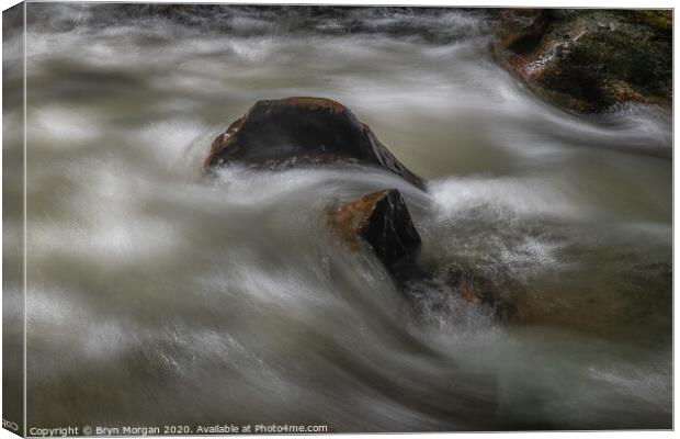Boulder with flowing water Canvas Print by Bryn Morgan