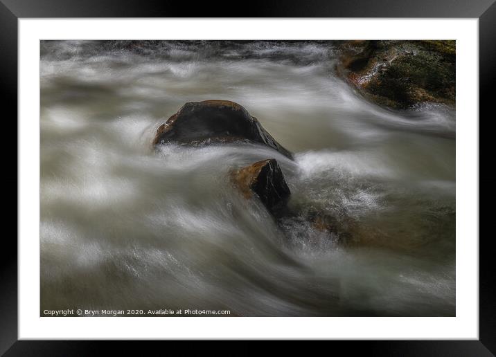 Boulder with flowing water Framed Mounted Print by Bryn Morgan