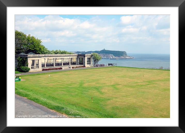 Shelter and putting green with the town in the background at Scarborough in Yorkshire Framed Mounted Print by john hill