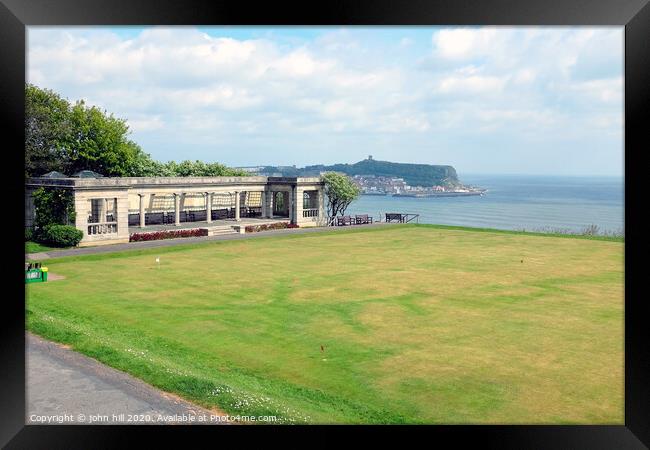 Shelter and putting green with the town in the background at Scarborough in Yorkshire Framed Print by john hill