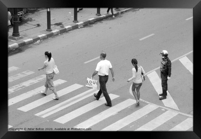 People on a pedestrian crossing in Bangkok. Framed Print by Peter Bolton