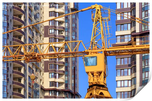 Crane between the facades and near the modern residential building under construction. Print by Sergii Petruk