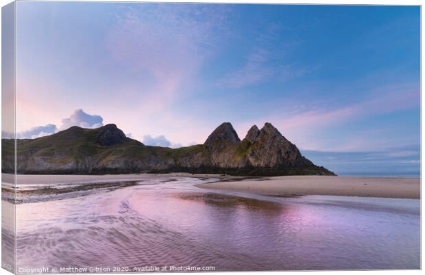 Beautiful colorful Summer sunrise landscape image of Three Cliffs Bay in South Wales Canvas Print by Matthew Gibson