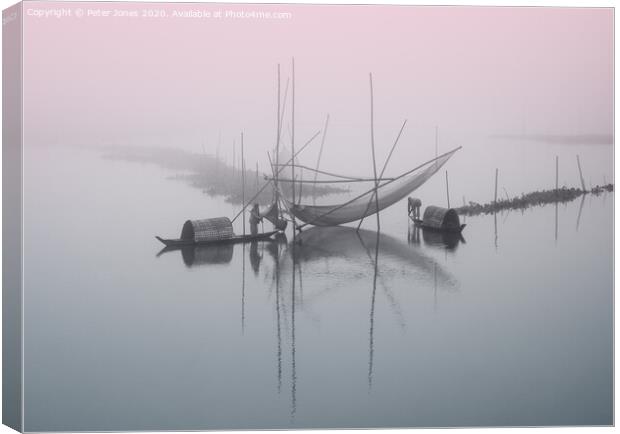 Two fishermen attend to their nets Canvas Print by Peter Jones
