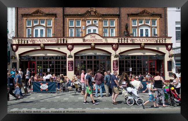 Summer visitors outside the old Borough Hotel public house on the seafront at Southend on Sea, Essex. Framed Print by Peter Bolton