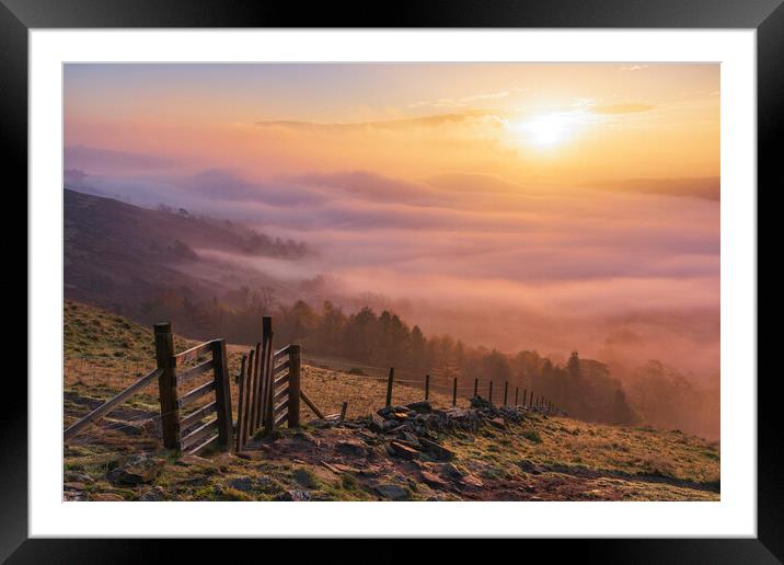 Glowing sunrise above fog Framed Mounted Print by John Finney