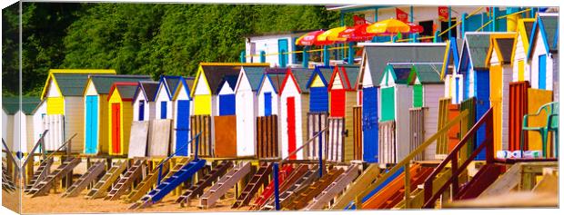 Bright Beach huts Canvas Print by Dave Bell