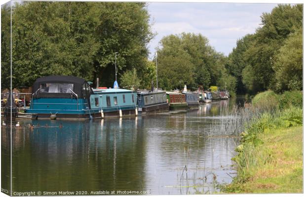 Barges moored on the Kennet and Avon Canal Canvas Print by Simon Marlow