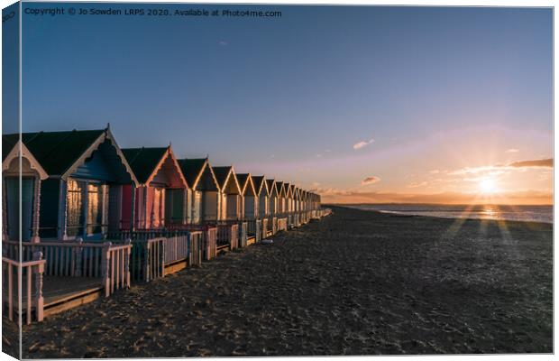Sunset at West Mersea Beach Huts Canvas Print by Jo Sowden