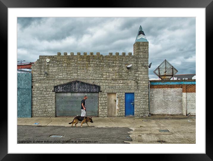 Man and dog walk in front of abandoned seaside arcade at Southend on Sea, Essex. Framed Mounted Print by Peter Bolton