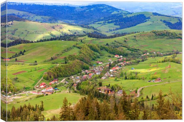 Beautiful landscape of the Carpathian Mountains, Ukraine, overlooking the village from the top of the mountain. Canvas Print by Sergii Petruk