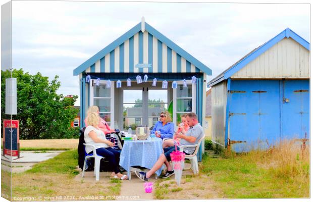 Beach hut tea party on the promenade at Sutton on Sea in Lincolnshire. Canvas Print by john hill