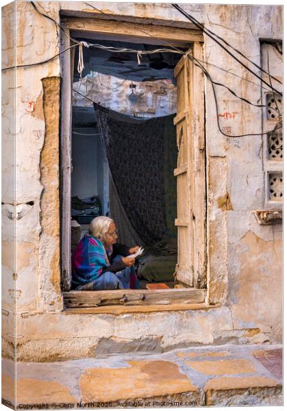 Lady reading letter in doorway, Jaisalmer Fort. Canvas Print by Chris North