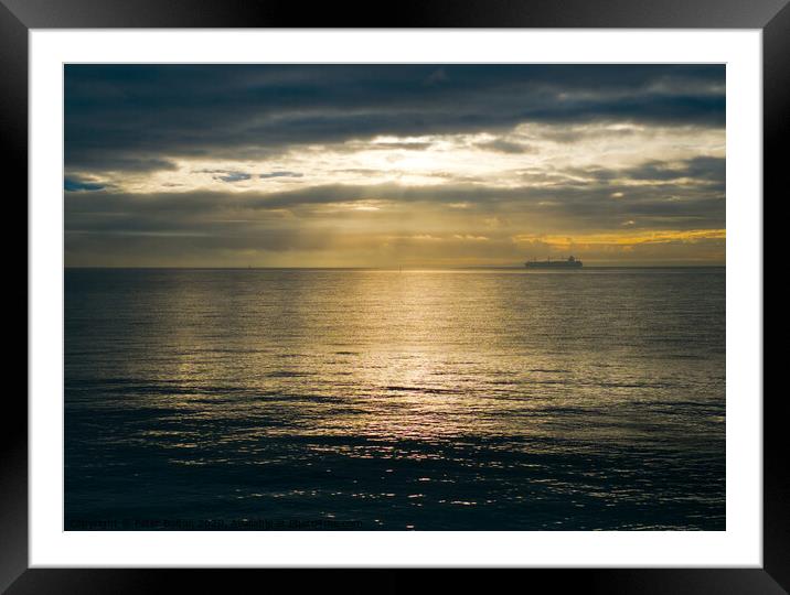 Wide view of The Thames Estuary off the Essex coast with changeable weather on the horizon. A ship on the horizon makes its way downriver. Framed Mounted Print by Peter Bolton