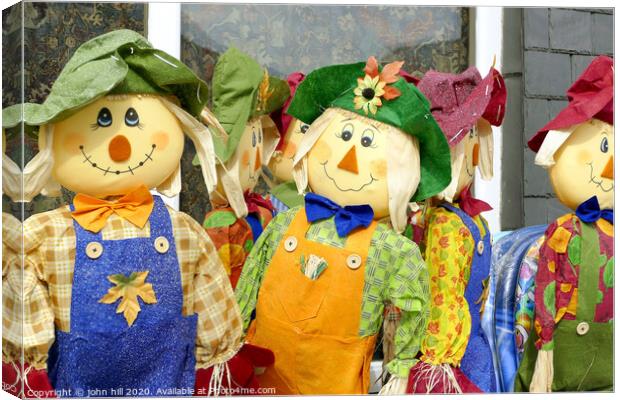 Homemade Scarecrows for sale outside a shop at Porthmadog in Wales.  Canvas Print by john hill