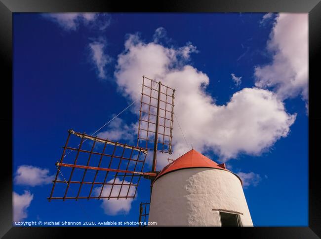 Windmill and sails on a sunny day in Lanzarote, Ca Framed Print by Michael Shannon