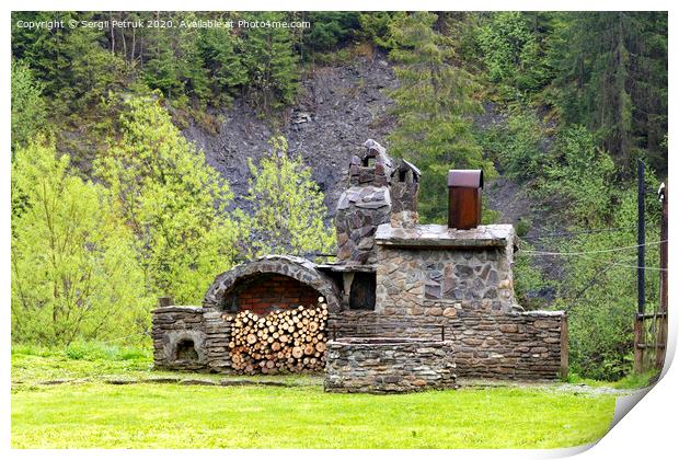 Old stone stove with firewood and smokehouse in the mountains of the Carpathians. Print by Sergii Petruk