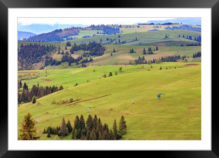 Landscape of the spring Carpathian mountains with blue masts of a mountain cable lift leading to the top of the mountain. Framed Mounted Print by Sergii Petruk