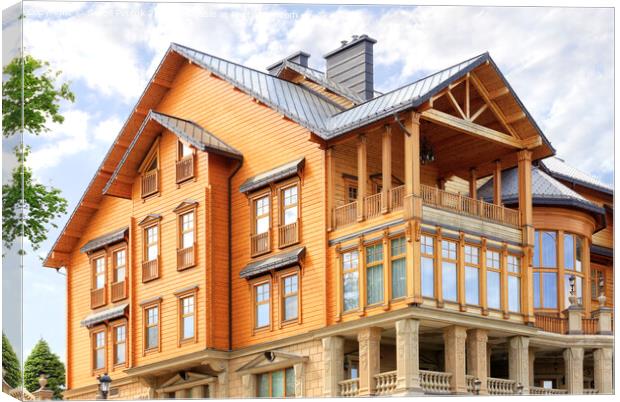 The facade of a beautiful wooden house in three floors. Canvas Print by Sergii Petruk