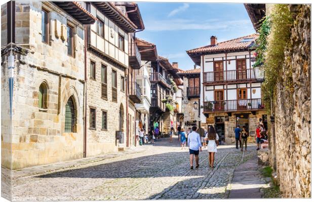 Tourists walking around the town in Santillana, Sp Canvas Print by Kevin Hellon