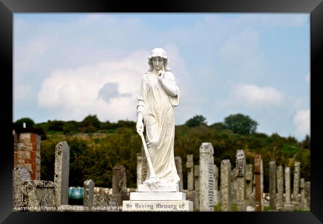 Statue and graveyard Framed Print by Fiona Williams