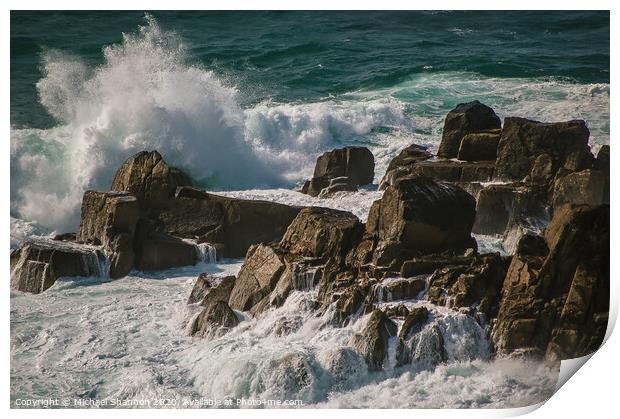 Waves crash against the rocks at Lands End, Cornwa Print by Michael Shannon