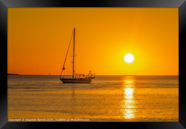 Yacht in orange sunset Framed Print by Stephen Rennie