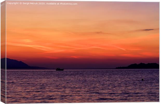 Silhouette of a sea boat running along the horizon of the sea line against the backdrop of a beautiful, vibrant sunset on the Gulf of Corinth. Canvas Print by Sergii Petruk