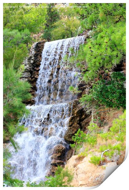 Large waterfall with radon water among the boulders at the foot of the mountain in Loutraki, Greece, vertical image. Print by Sergii Petruk