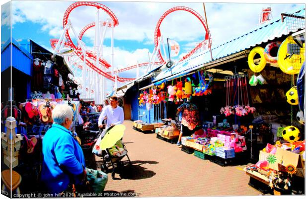 Ingoldmells outdoor market with funfair behind at Skegness in Lincolnshire. Canvas Print by john hill