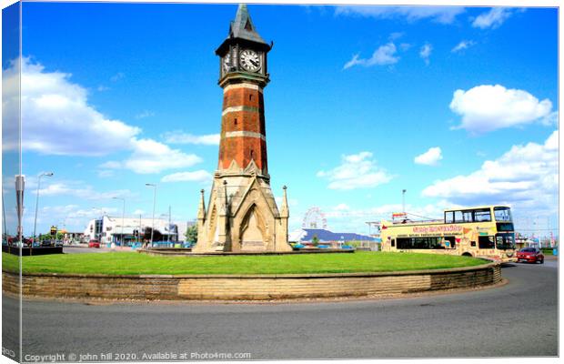 The landmark clock tower against a blue sky at Skegness in Lincolnshire. Canvas Print by john hill