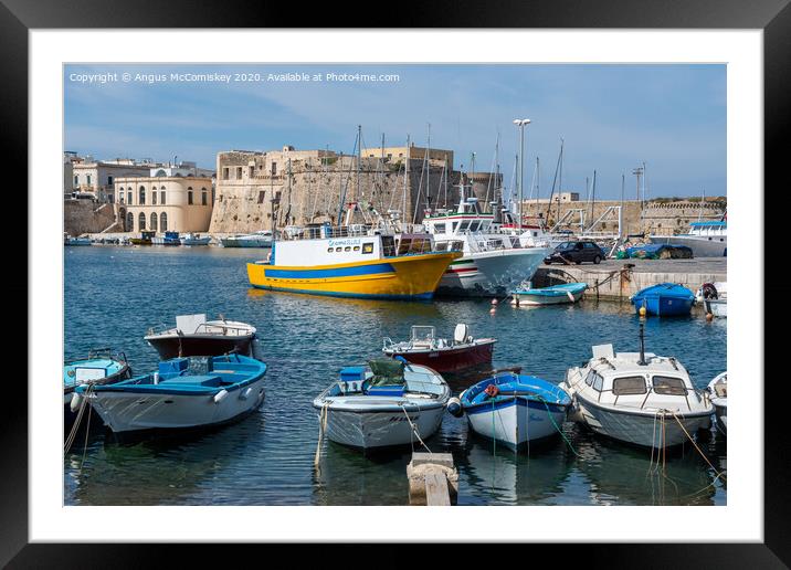 Boats tied up in Gallipoli harbour in Puglia Framed Mounted Print by Angus McComiskey