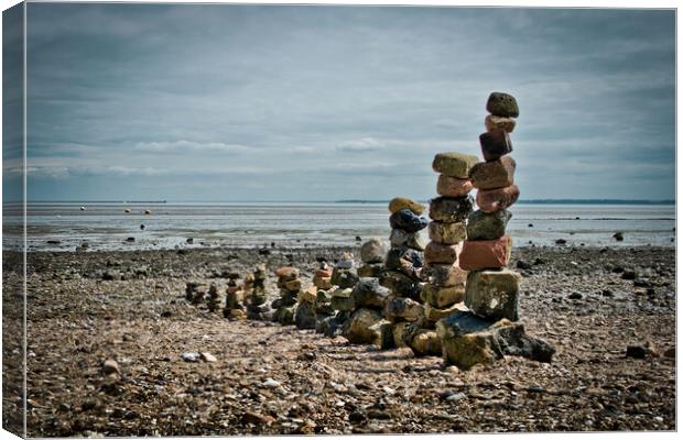 'Land art' on East Beach, Shoeburyness, Essex, UK. made from found stones, and rocks. Remains of historic victorian military buildings on the shoreline. Canvas Print by Peter Bolton