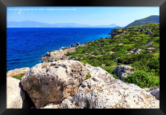 The coastline of the Ionian Sea is dotted with large stone boulders. Framed Print by Sergii Petruk