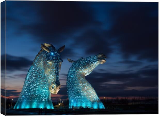 The Kelpies, Illuminated in blue at night. Canvas Print by Tommy Dickson