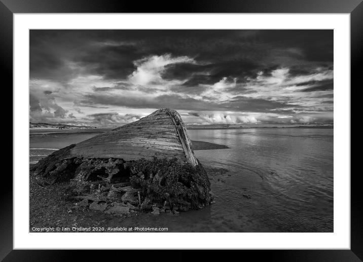 Shipwreck on a beach. Framed Mounted Print by Iain Cridland