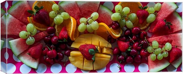 A colourful Christmas breakfast fruit platter on a dining table closeup. Canvas Print by Geoff Childs