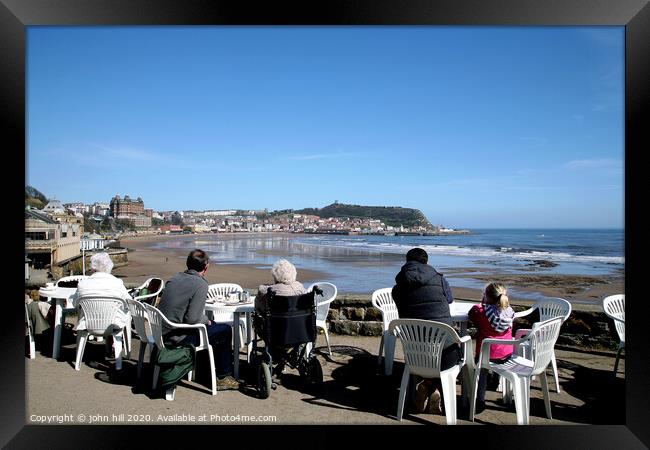 Tourists enjoying the view of Scarborough over the bay at low tide Framed Print by john hill