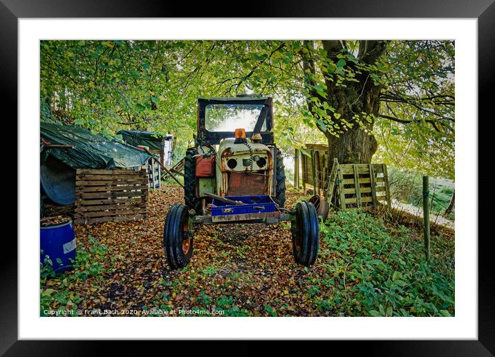 Worn out tractor placed in an autumn forest, Denmark Framed Mounted Print by Frank Bach