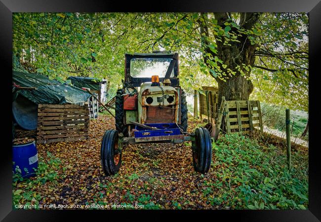 Worn out tractor placed in an autumn forest, Denmark Framed Print by Frank Bach