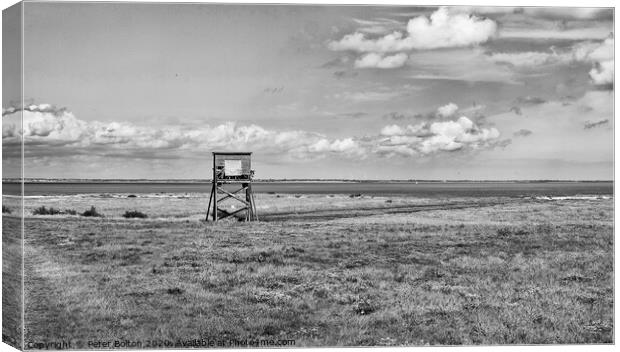 Black and white landscape of coastal nature reserve with an observation hide. At Bradwell, Essex. Canvas Print by Peter Bolton