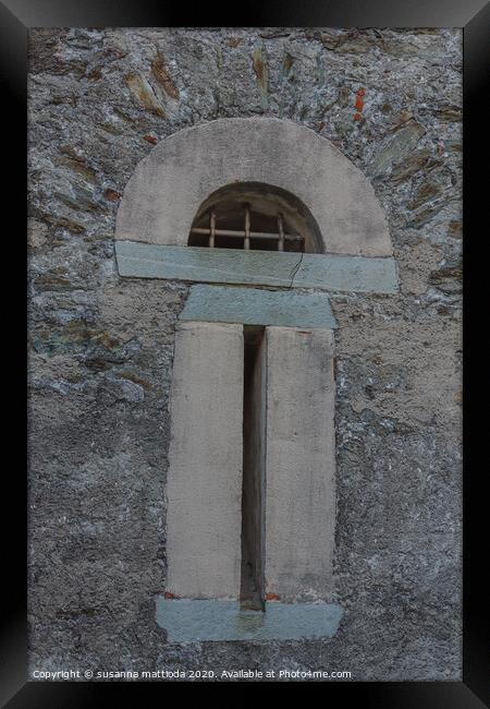 a slit  with security grating of an ancient castle Framed Print by susanna mattioda