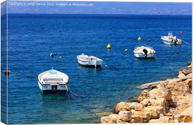 Powerboats and boats are anchored along the rocky coast of the Ionian Sea. Canvas Print by Sergii Petruk