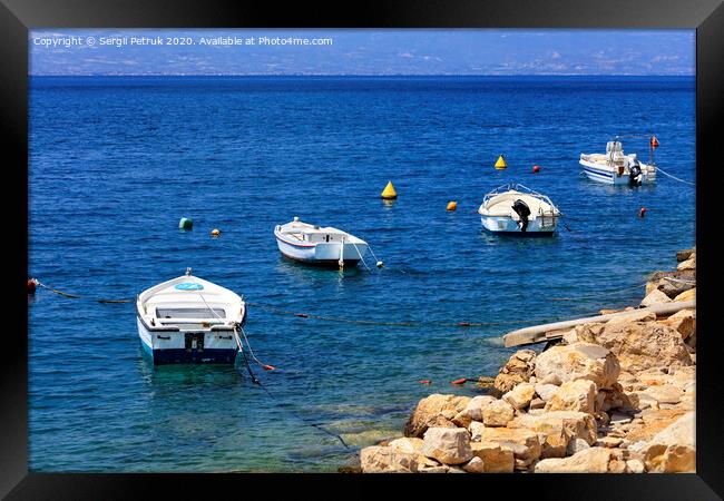 Powerboats and boats are anchored along the rocky coast of the Ionian Sea. Framed Print by Sergii Petruk